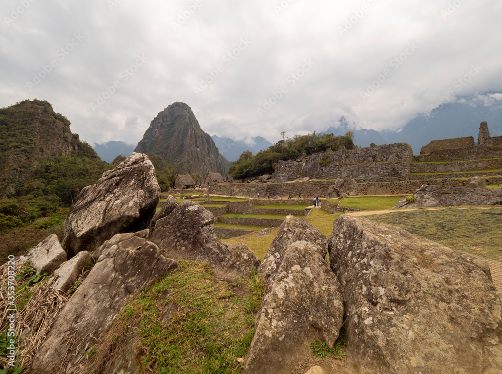 Stones used to fabricate Machu picchu buildings, Stone walls, mountains and terraces on the background