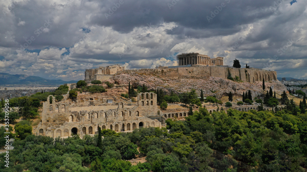 Aerial drone photo of Acropolis of Athens in Attica, Greece, with the Parthenon Temple on top of the hill during a cloudy spring day