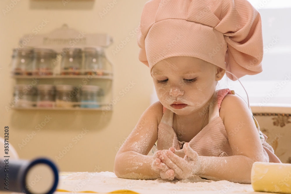 Little girl cooks at home in the kitchen Little girl cooks at home in the kitchen