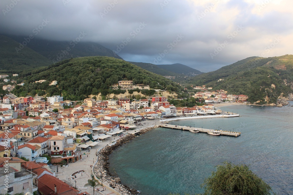 Panorama of Parga town and harbor in Preveza in Epirus, Greece in a cloudy day at summer season. Parga lies on the Ionian coast between the cities of Preveza and Igoumenitsa