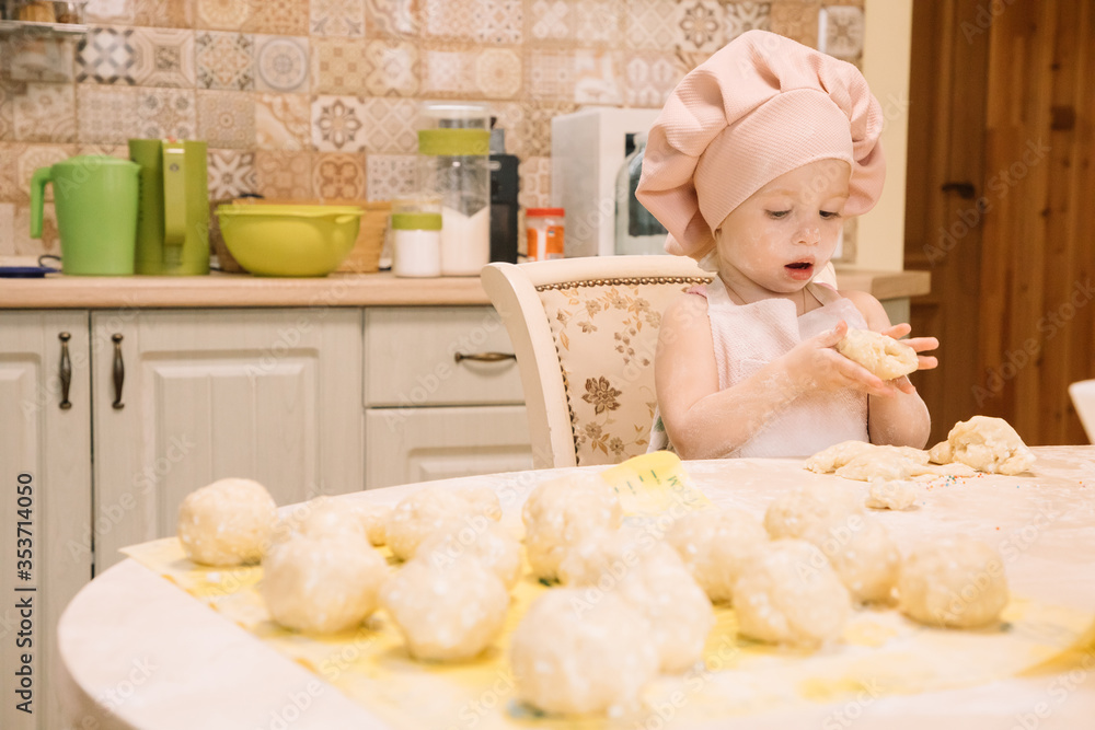 Little girl cooks at home in the kitchen Little girl cooks at home in the kitchen