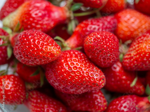 Harvest of red tasty strawberries closeup