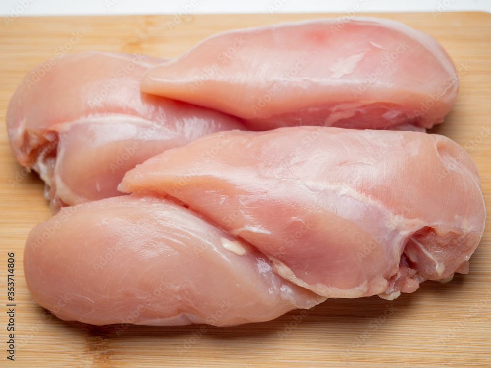 Fresh chicken fillet on a wooden board