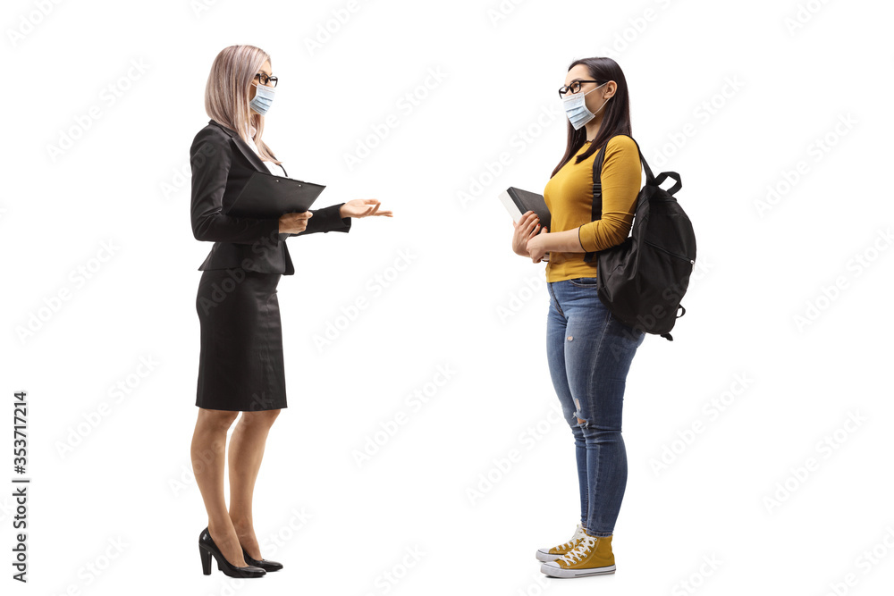 Businesswoman protective face talking to a female student Businesswoman protective face talking to a female student