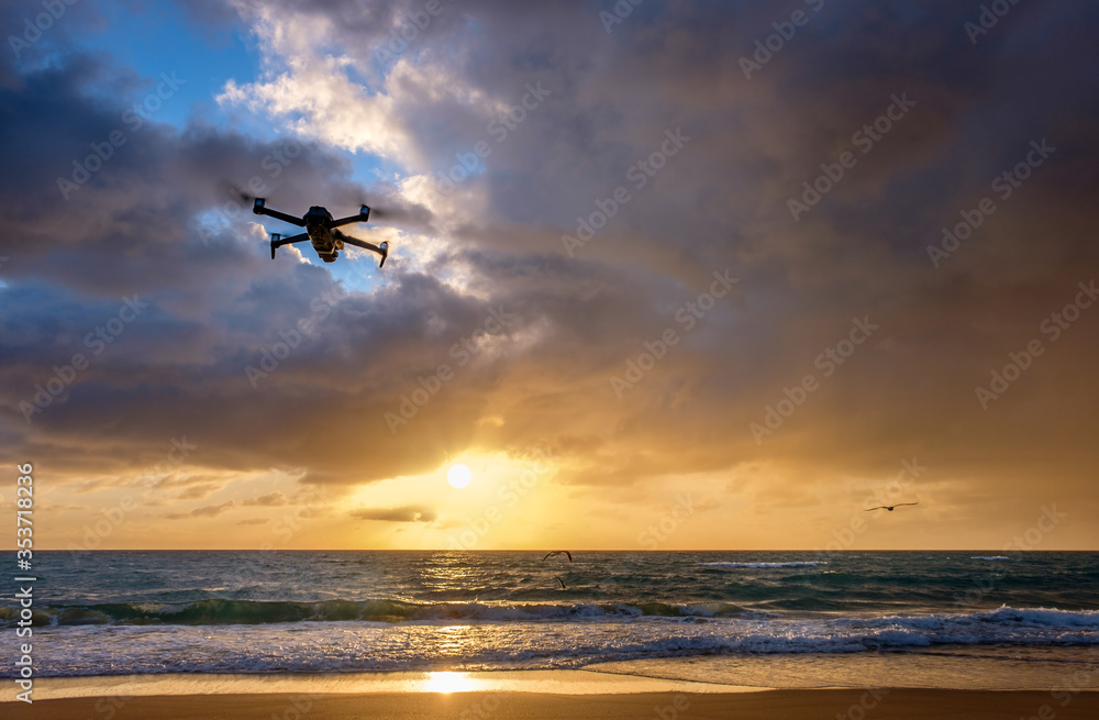 Drone flying over beach at sunset Drone flying over beach at sunset