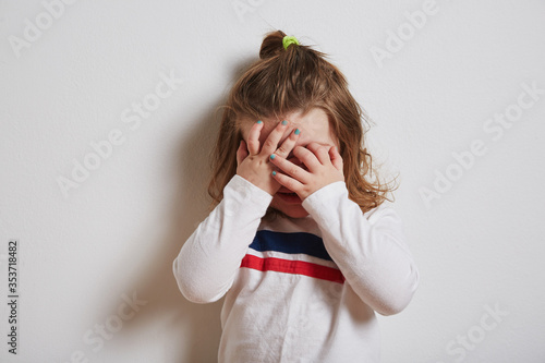 Girl covering her eyes photo