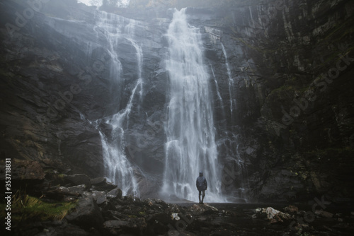 Man standing by Skjervefossen waterfall in Norway photo