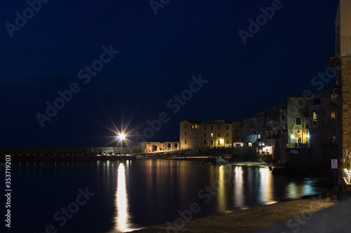 Cefalu at night, Sicily, Italy. Seascape, cityscape. View on harbor and old houses. September 2019