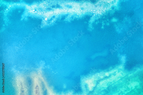Turquoise colored shallow water surface with bottom visible aerial