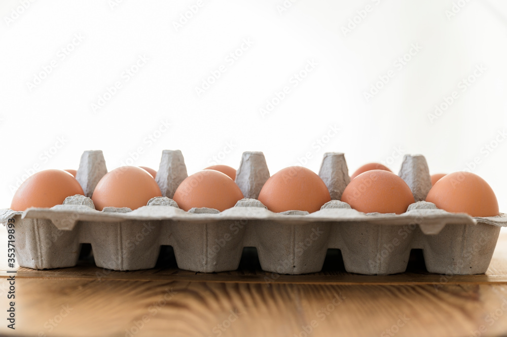 Carton of eggs on wooden table Carton of eggs on wooden table
