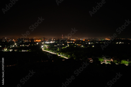 Aerial view of night town from Hill after sunset - modern city with spectacular nightscape panorama. aerial view, night city with night sky. natural summer night. horizontal © MONIUK ANDRII