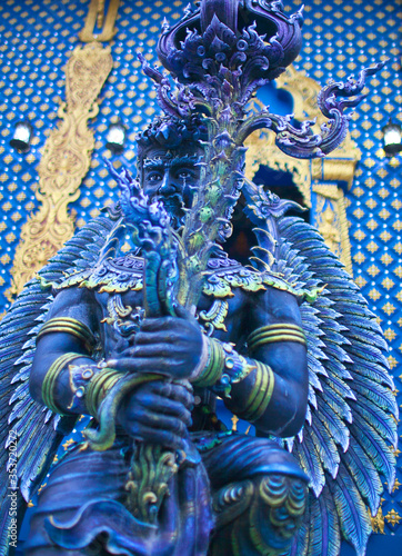 Blue statue of the Guard in Thai Lanna style - detail of exteror of Wat Rong Suea Ten, or Blue Temple in Chiang Rai, Northern Thailand