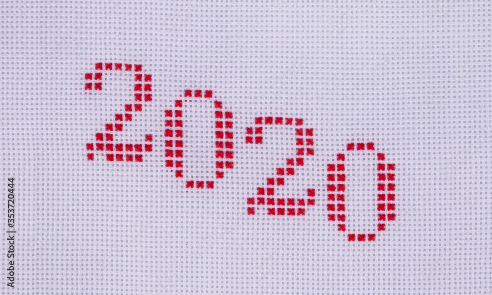 numbers two thousand twenty embroidered with red threads obliquely from top to bottom close-up