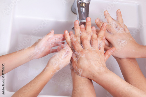 Good hygiene - a great habit - cleaning the hands of three young women