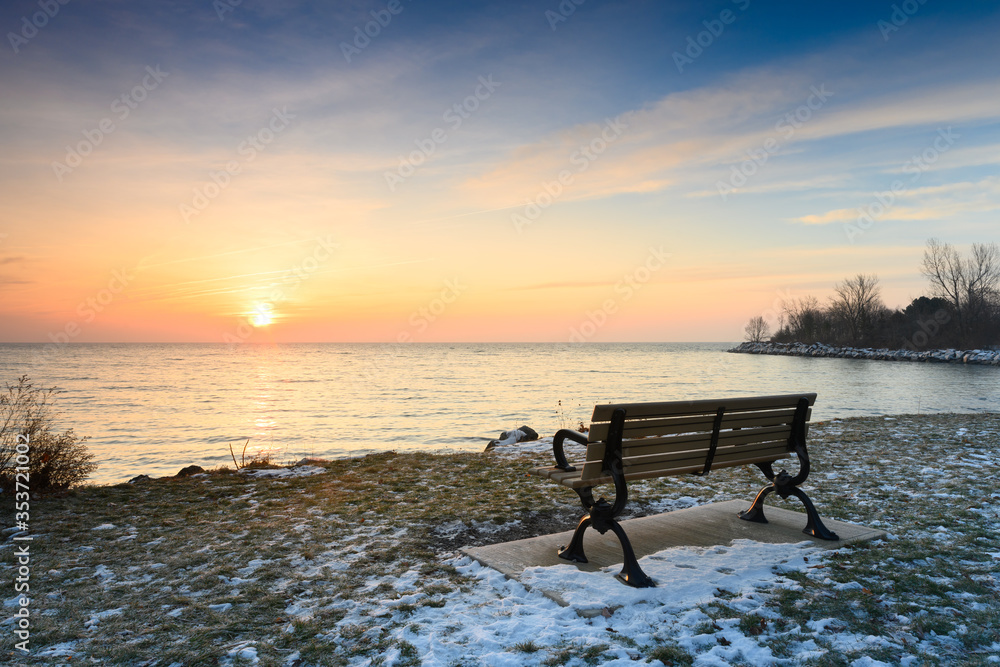 The sun brings light back into the world following the long, dark winter solstice, as seen from Toronto, Ontario's popular Ashbridges Bay Park along the shore of Lake Ontario.