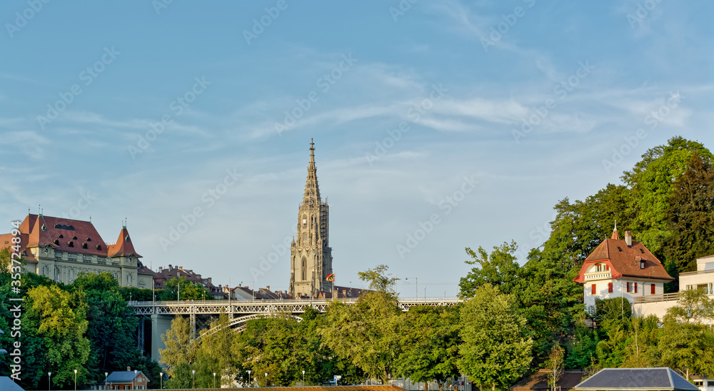 View of Kirchenfeld bridge over the river Aare, with Cathedral in the background, in Bern, Switzerland
