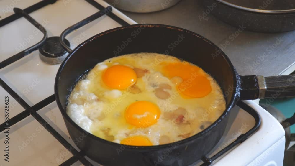 Eggs are fried in a pan. Cooking fried egg Eggs are fried in a pan. Cooking fried egg
