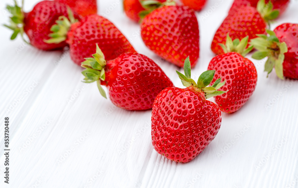Fresh strawberries. On a white wooden background