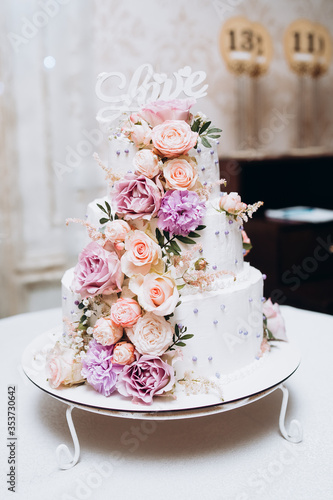 Obraz na płótnie Cake traditional anniversary birthday wedding three-layer. White wedding cake with pink flowers for wedding banquet. Delicious wedding reception. Copy space. Celebration party concept. Trendy Cake. w salonie