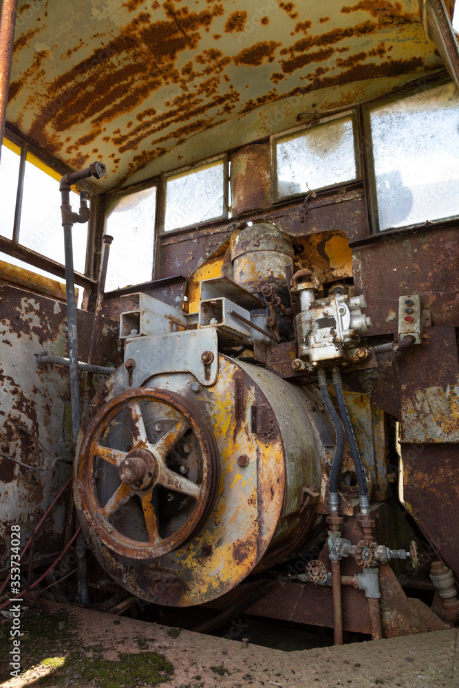 An interior view of an old street car's engine and mechanical workings

