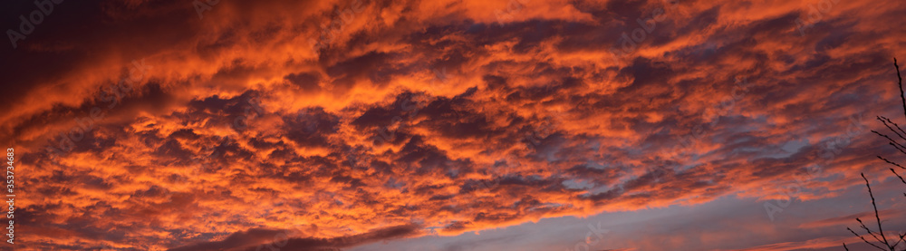 bright orange sky lit by the setting sun. Panorama.