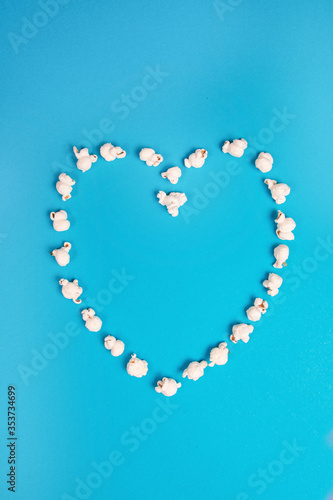 Romantic heart made out of popcorn on a blue background