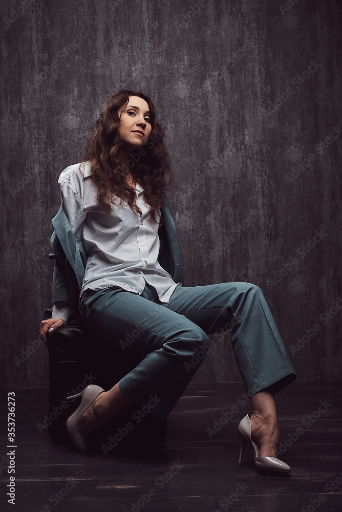 Beautiful girl in a suit and a man's shirt shoes Beautiful girl in a suit and a man's shirt shoes
