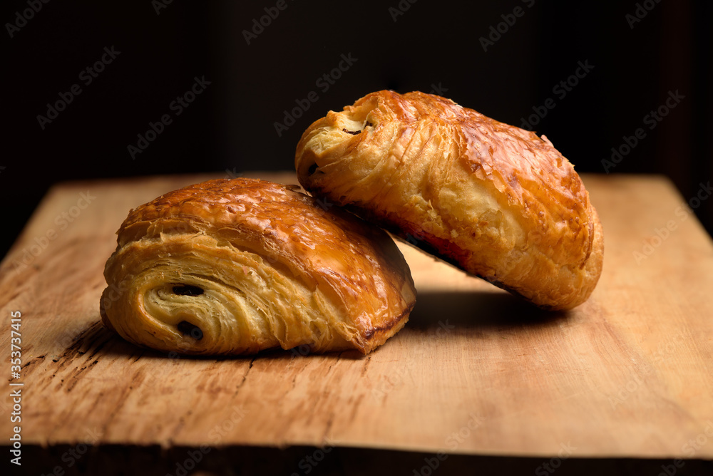 two pain du chocolat on a board
