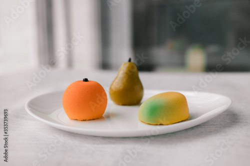 cakes in the form of fruits on a white plate