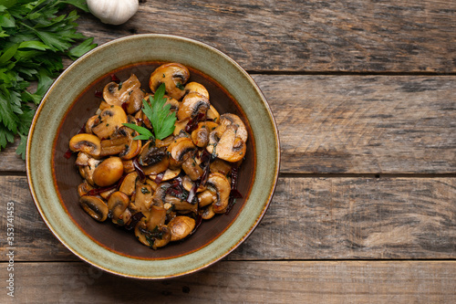 Mexican mushrooms with garlic and guajillo chili peppers also called "al ajillo" on wooden background