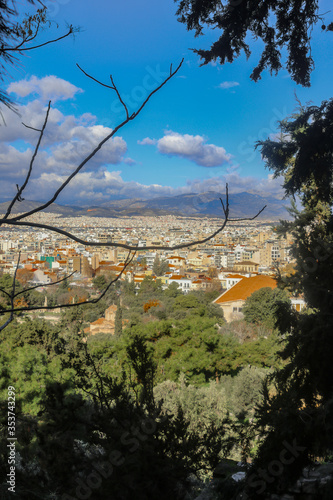 Εκτύπωση καμβά Rooftops of Athens viewed through frame of tree branches from Acropolis