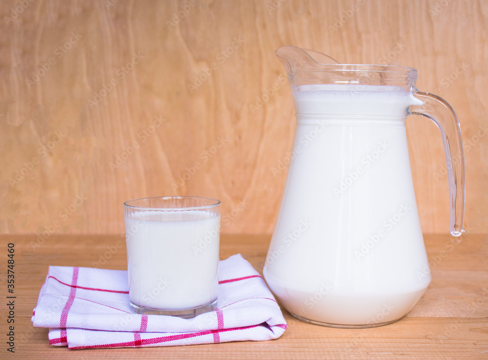 Tasty fresh milk on a wooden background. Carafe with milk and a glass of milk, cottage cheese. view from above. copy space Tasty fresh milk on a wooden background. Carafe with milk and a glass of milk, cottage cheese. view from above. copy space