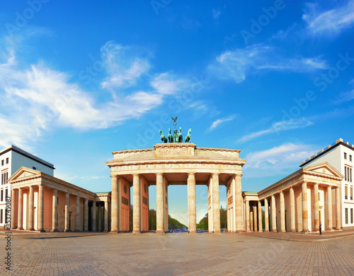 Brandenburg Gate in Berlin  Germany. Panoramic image  symmetrical front shot on a bright day with blue sky and light feather clouds