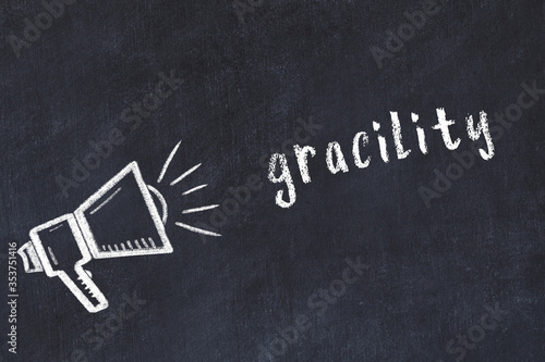 Photos Chalk loudspeaker and inscription gracility on black chalkboard