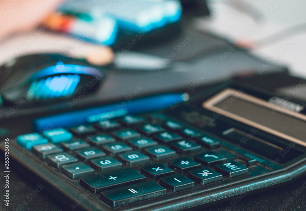 Business composition on a table from a calculator monitor and mouse Business composition on a table from a calculator monitor and mouse