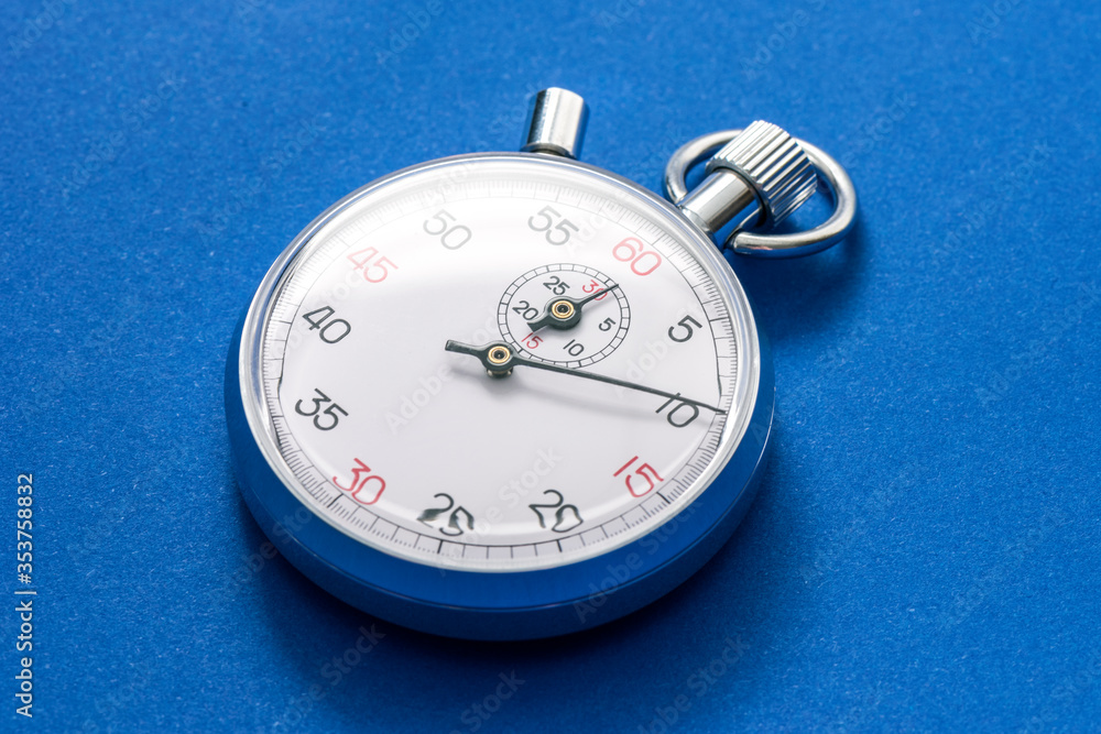 Analogue metal stopwatch on the blue background. Analogue metal stopwatch on the blue background.