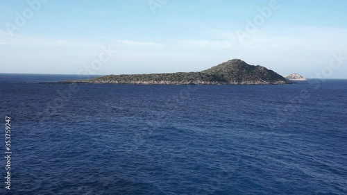 KAS, ANTALYA, TURKEY, MAY 22, 2020: Video of waves in a windy sunny morning with a blue sky and an island. Kaputas Beach.
