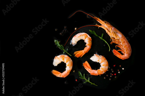 Obraz na plátne Four king prawns on a black background