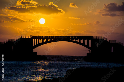 Fototapeta Naklejka Na Ścianę i Meble -  sunset over the bridge at Alexandria and there is a fisherman who fish under the bridge 