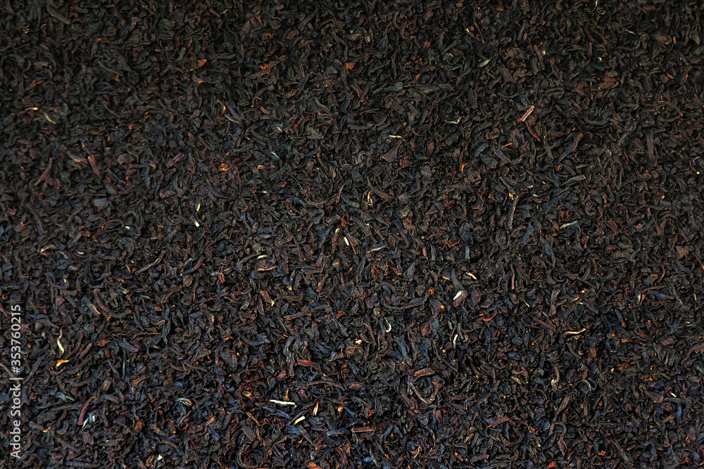 Tea background, black tea leaves top view, close-up Tea background, black tea leaves top view, close-up