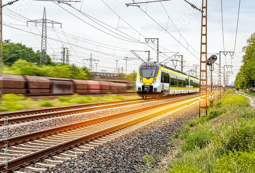 High-speed yellow train traffic on rails. Carry passengers with comfort