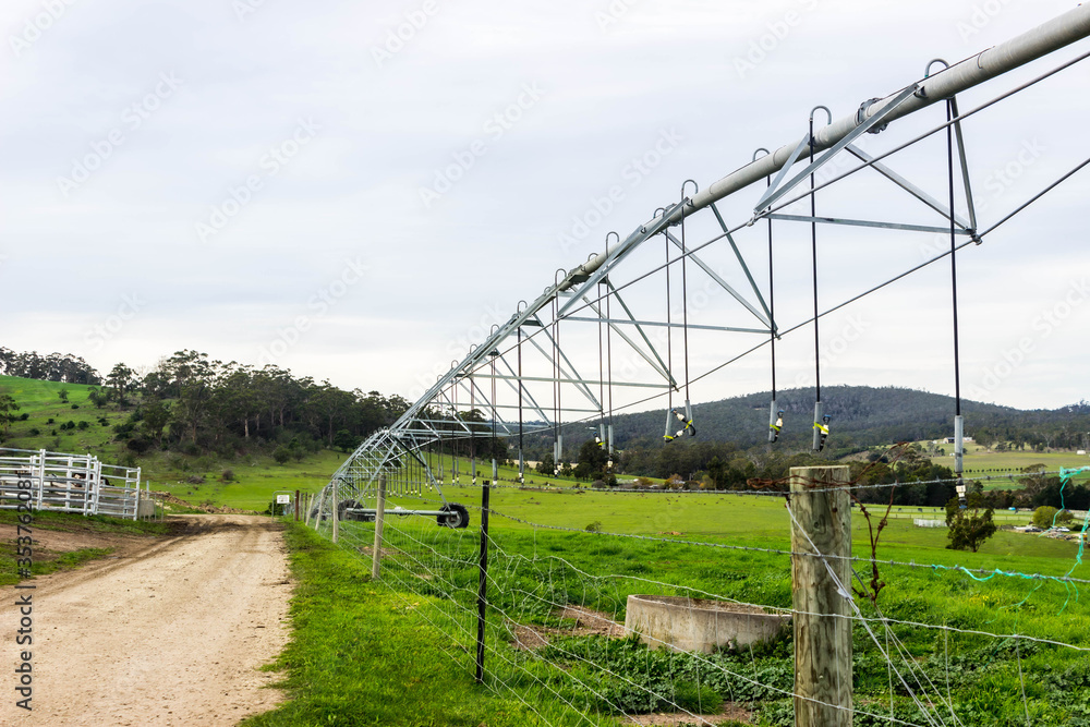 Fototapeta premium farm irrigation sprinkler in rural field 