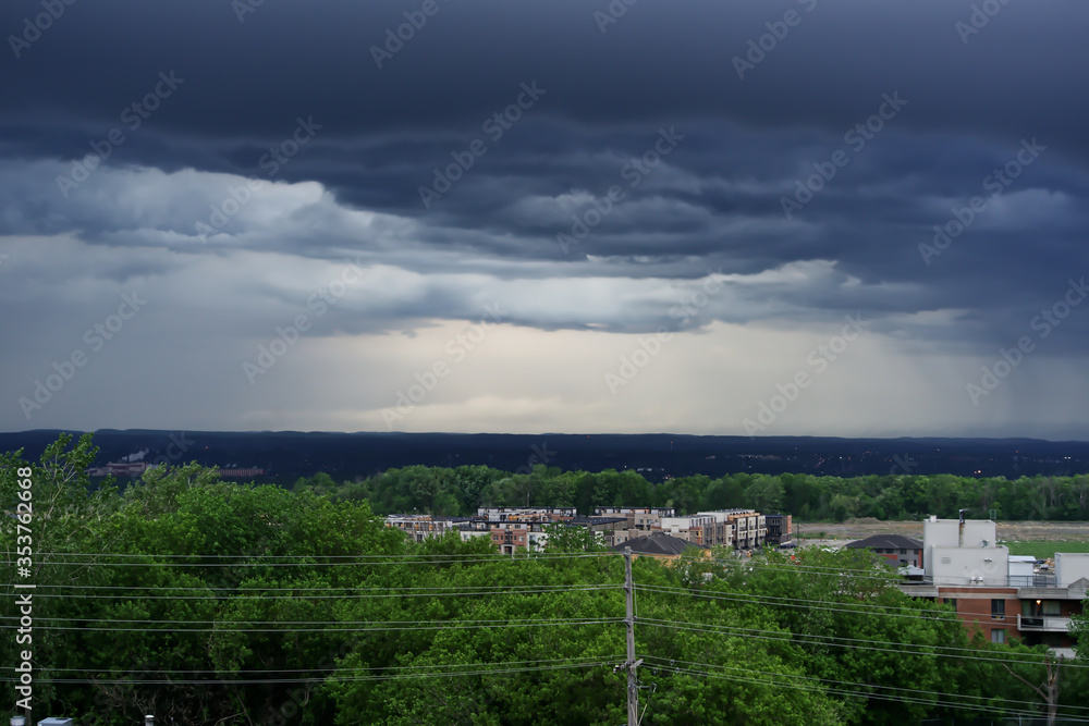 A dark storm front moves in over a city