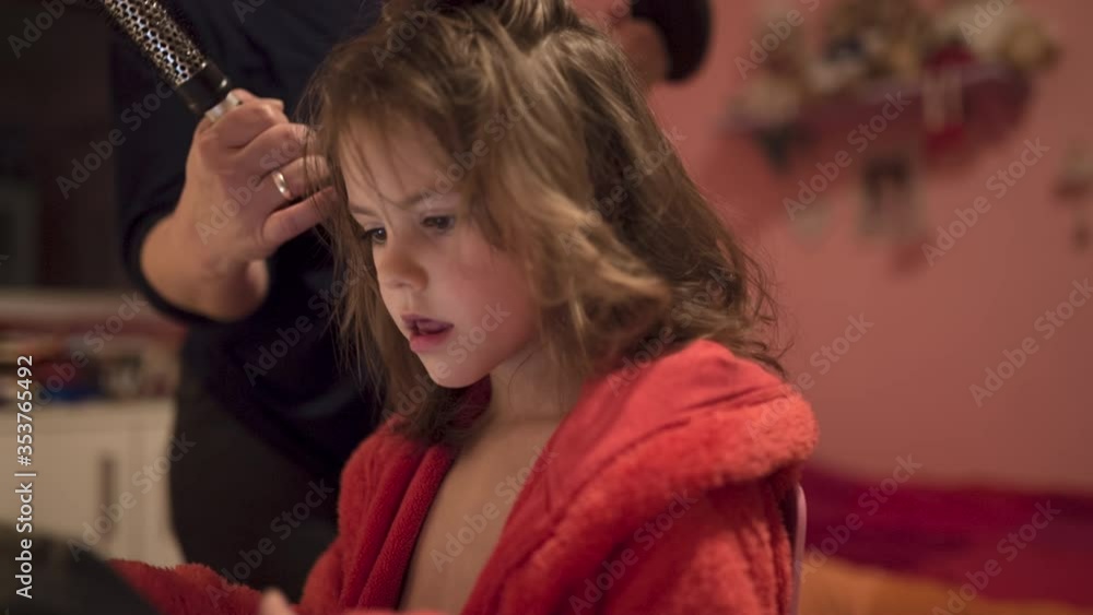 Single mother drying hair to her adorable daughter in bathrobe Single mother drying hair to her adorable daughter in bathrobe