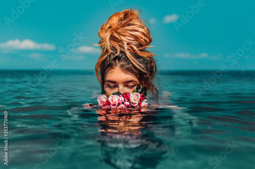 Canvas Print beautiful young woman swimming in sea with wreath conceptual fashion portrait