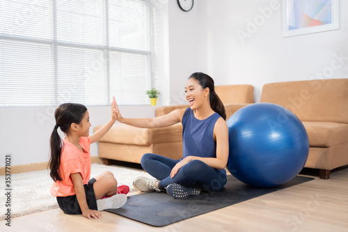Mother and daughter exercise at home