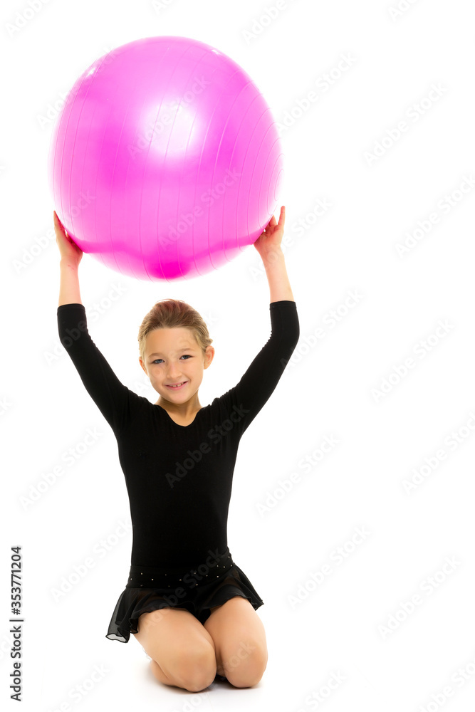 little girl doing exercises on a big ball for fitness. little girl doing exercises on a big ball for fitness.