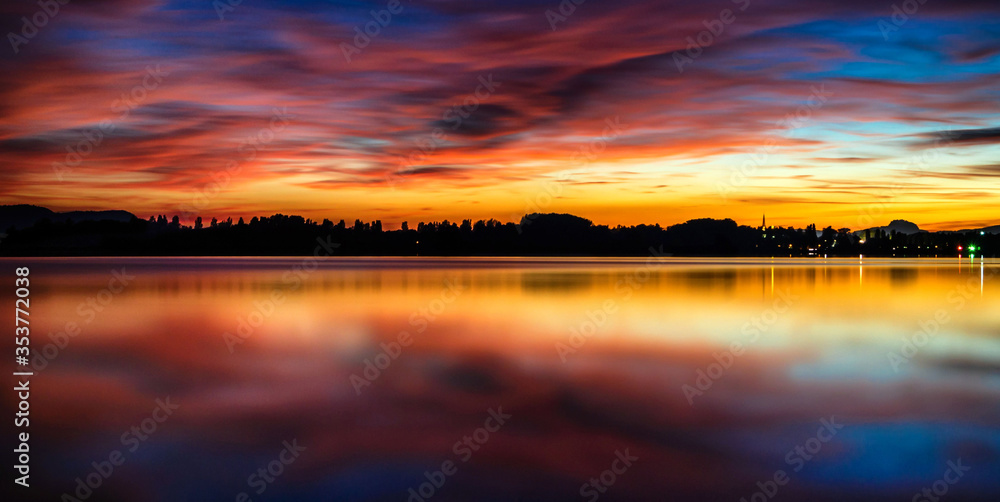 Colorful sunset on Lake Constance with colorful clouds in the sky
