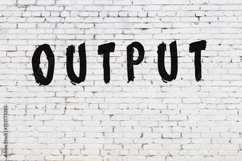 Word output painted on white brick wall photo