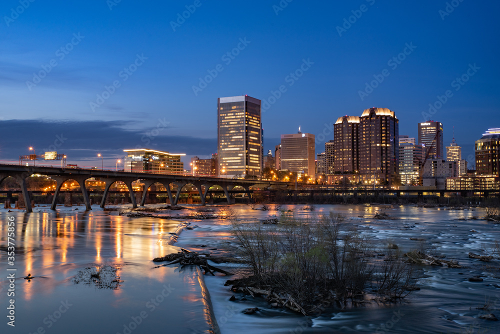 Downtown Richmond skyline at dusk. An evening view of Richmond's business district skyline by the James River. 